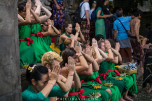 A few Balinese people surrounded by tourist during the purification ritual.